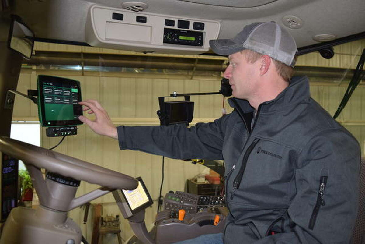 Illinois Farm Bureau Young Leader Nathan Ring of Virginia updates software on a Gen. 3 Precision Planting monitor at J.O. Harris Sales to prep a planter for spring. Ring, along with the other group members, work various jobs in the agricultural field but all say they benefit from the program’s insight into the ag community.
