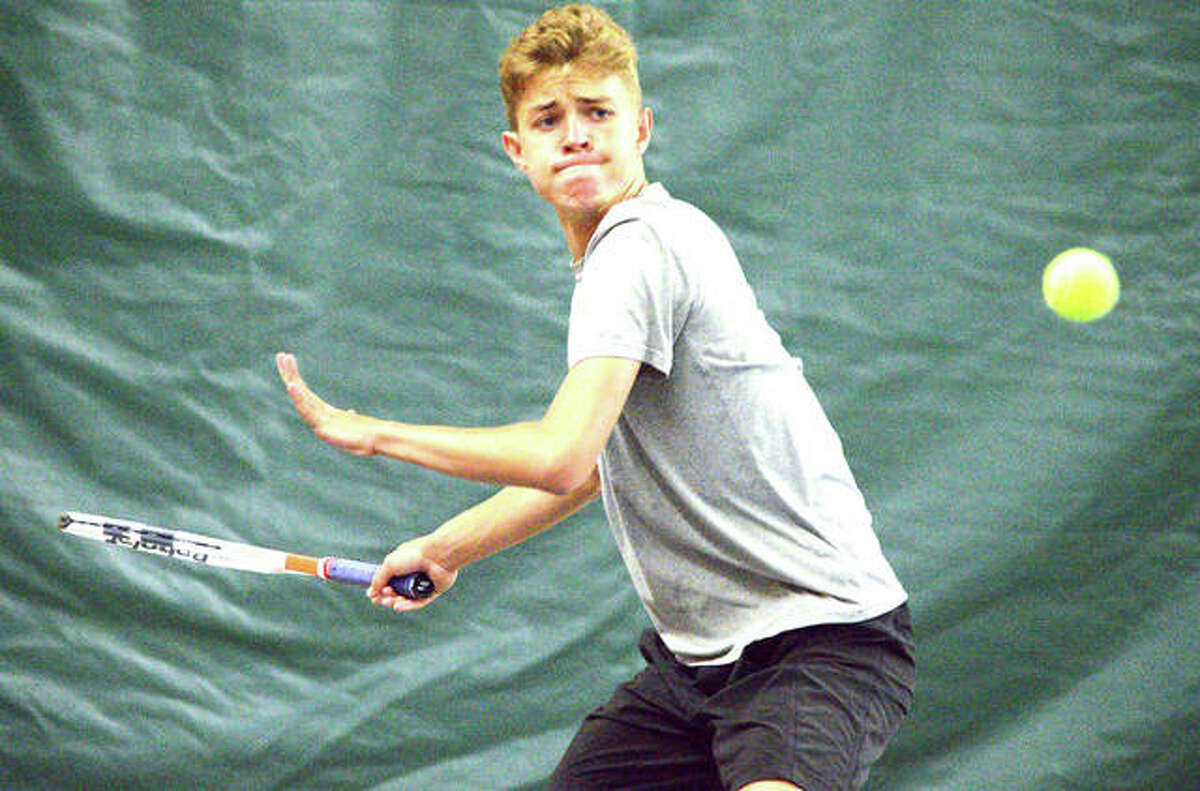 Edwardsville sophomore Ben Blake makes a forehand return during his No. 5 singles match against Normal University High Saturday at the Edwardsville Meyer Center YMCA.