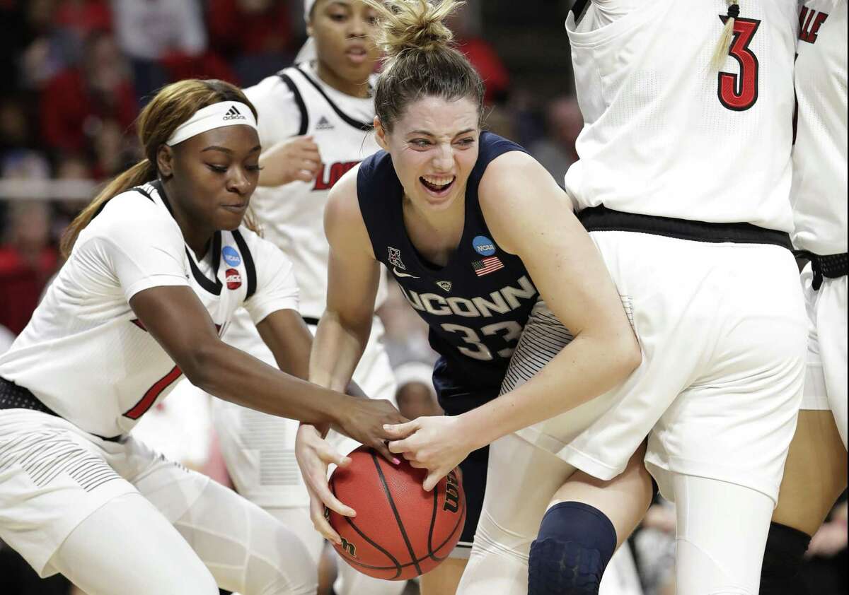 Louisville guard Dana Evans tries to strip the ball from UConn guard Katie Lou Samuelson during the first half of a regional championship final in the NCAA women's college basketball tournament Sunday in Albany, N.Y.