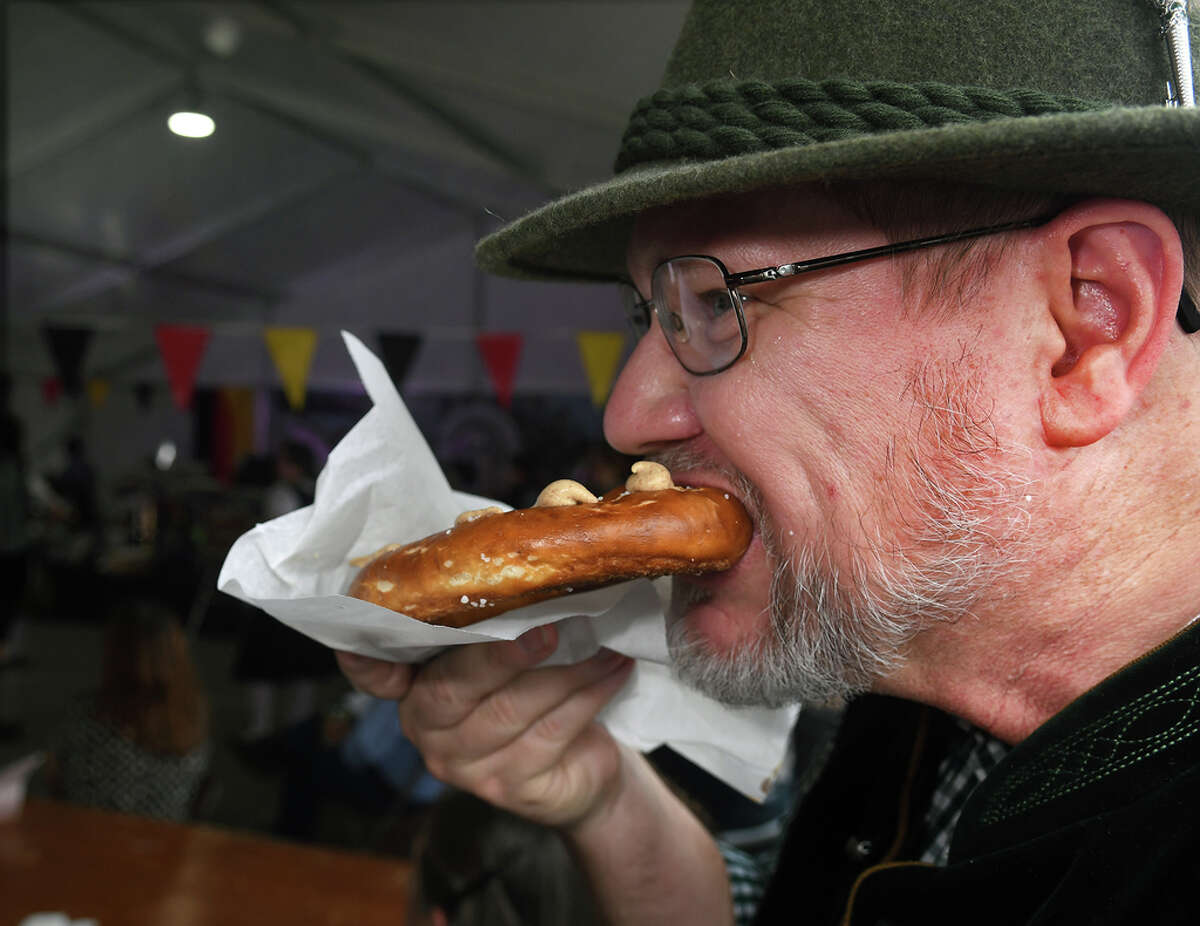 Jon Philippus, a member of the Round Top Brass Band of San Antonio, snacks on a pretzel while his band was between sets during the Tomball German Heritage Festival at the Tomball Depot on March 30, 2019.