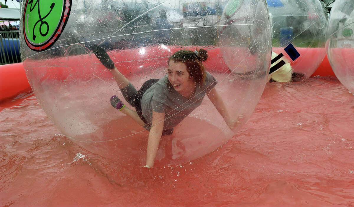 Desi Whaley, 14, an 8th grader at Tomball Junior High, takes a ride in a Bubble Runner, from The Woodlands, during the Tomball German Heritage Festival at Tomball Depot on March 30, 2019.