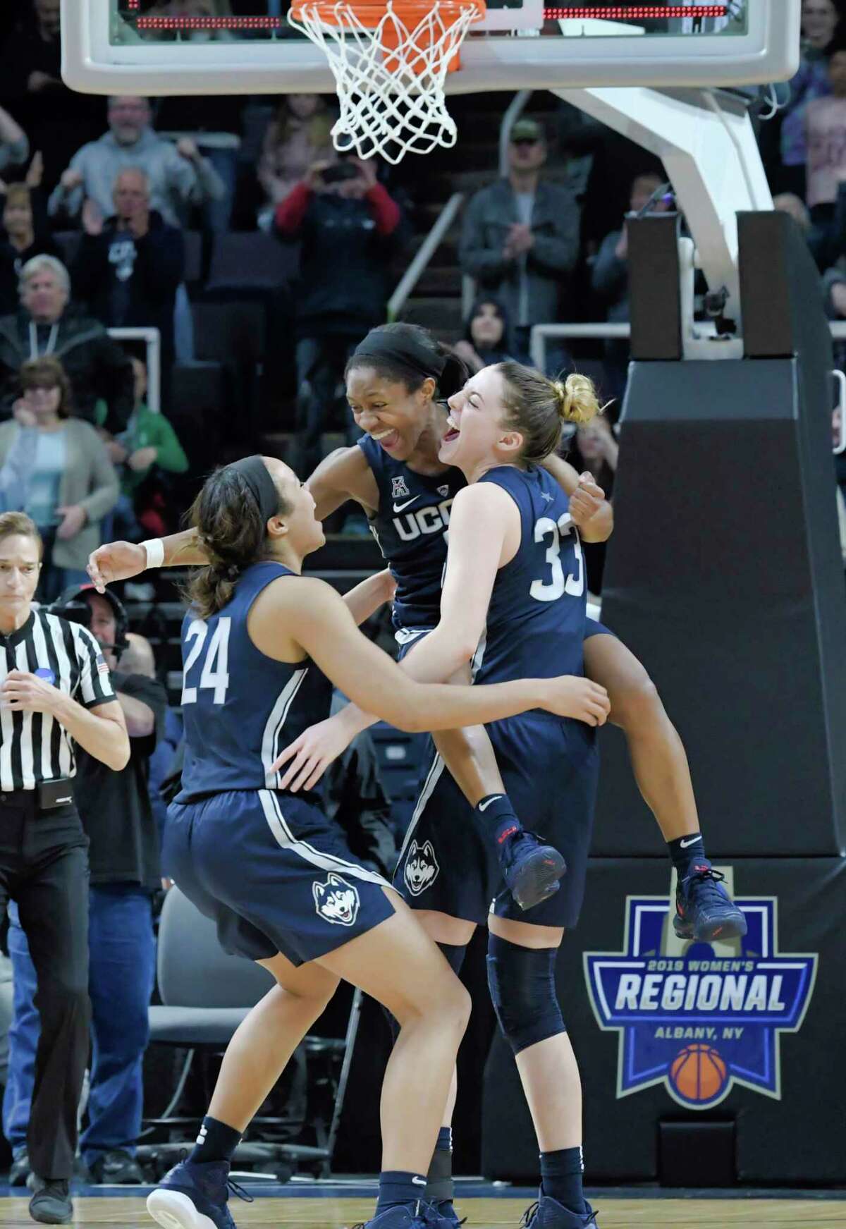 UConn's Napheesa Collier, left, Crystal Dangerfield, center, and Katie Lou Samuelson celebrate their win over Louisville in the final of the Albany Regional NCAA Women's Basketball Championship on Sunday, March 31, 2019, in Albany, N.Y. (Paul Buckowski/Times Union)