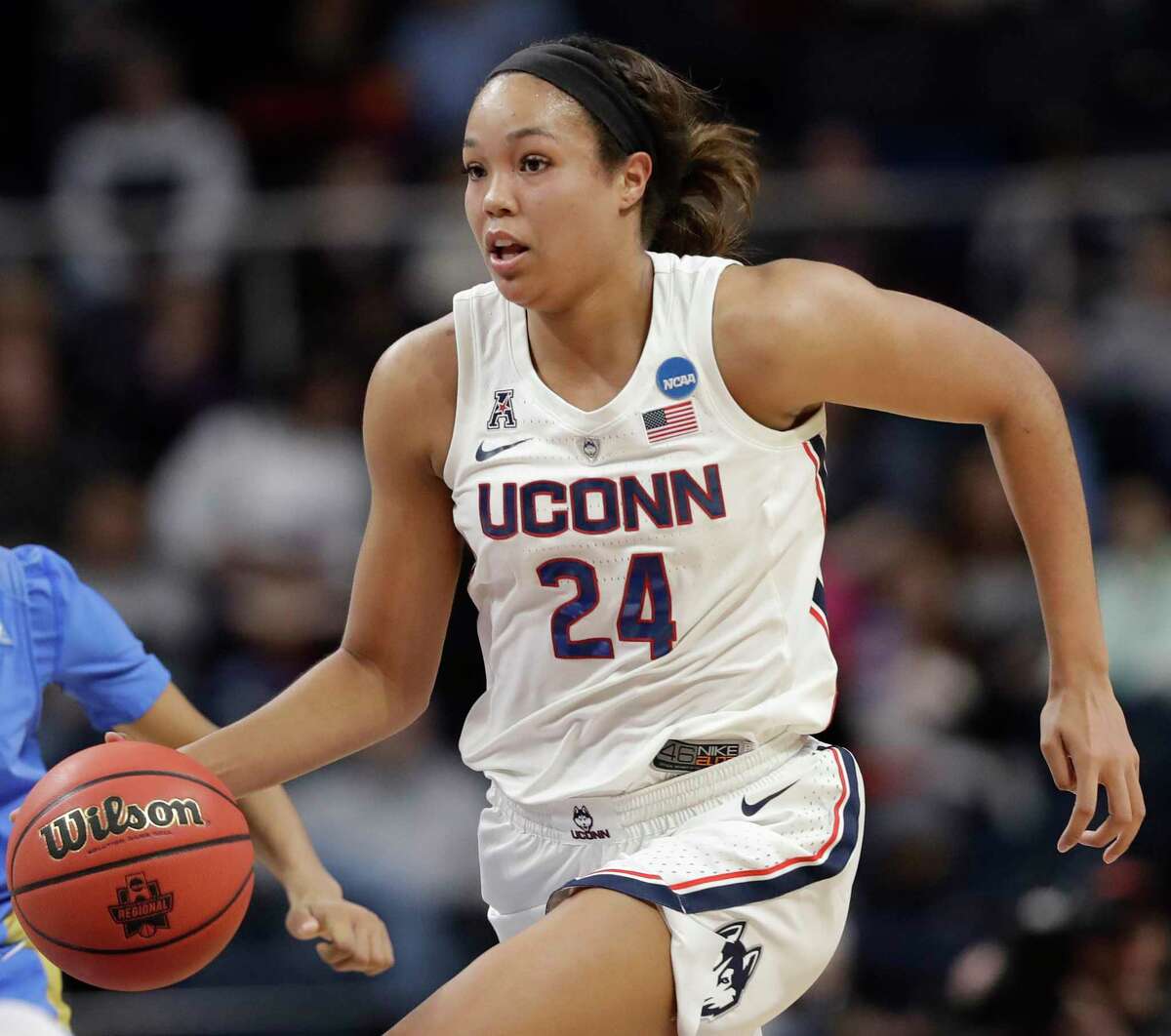 Connecticut forward Napheesa Collier (24) drives down court during the first half of a regional semifinal game in the NCAA women's college basketball tournament, Friday, March 29, 2018, in Albany, N.Y.