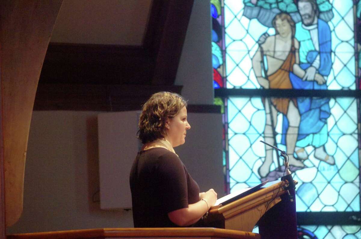 Amy Lappos, an aid for Congressman Jim Himes, reads a statement from him during the memorial service for Greenwich DTC Chairman Dave Roberson at the First Presbyterian Church Saturday afternoon, March 20, 2010. Roberson was killed in a car accident March 9, 2010.