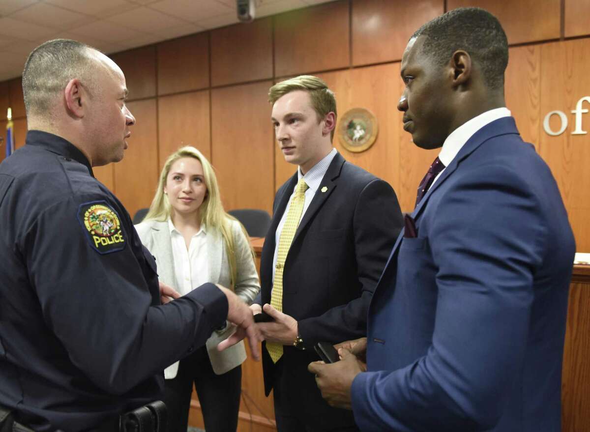 Greenwich Police Captain Kraig Gray, left, chats with new police recruits Sabrina Diaz, Thomas Koppelmann, and Vladimir Souffrant after they were sworn in at Town Hall in Greenwich, Conn. Monday, April 1, 2019. New police recruits Sabrina Diaz, Thomas Koppelmann, and Vladimir Souffrant were sworn in to the GPD at a ceremony for friends and family on Monday.