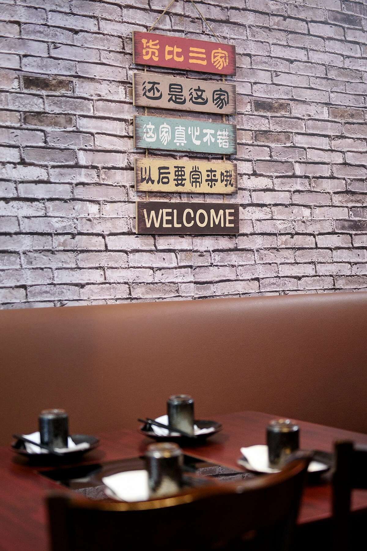 A welcome sign hangs on the wall at Woija Hunan Cuisine in Albany, Calif., on Thursday March 28, 2019.
