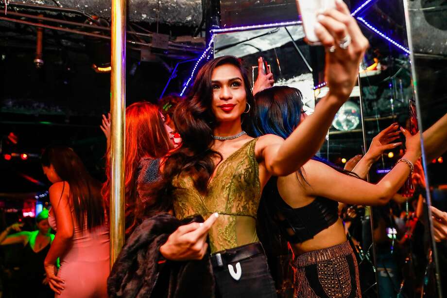 A dancer takes a selfie on a stage at Divas bar in San Francisco, Californi...