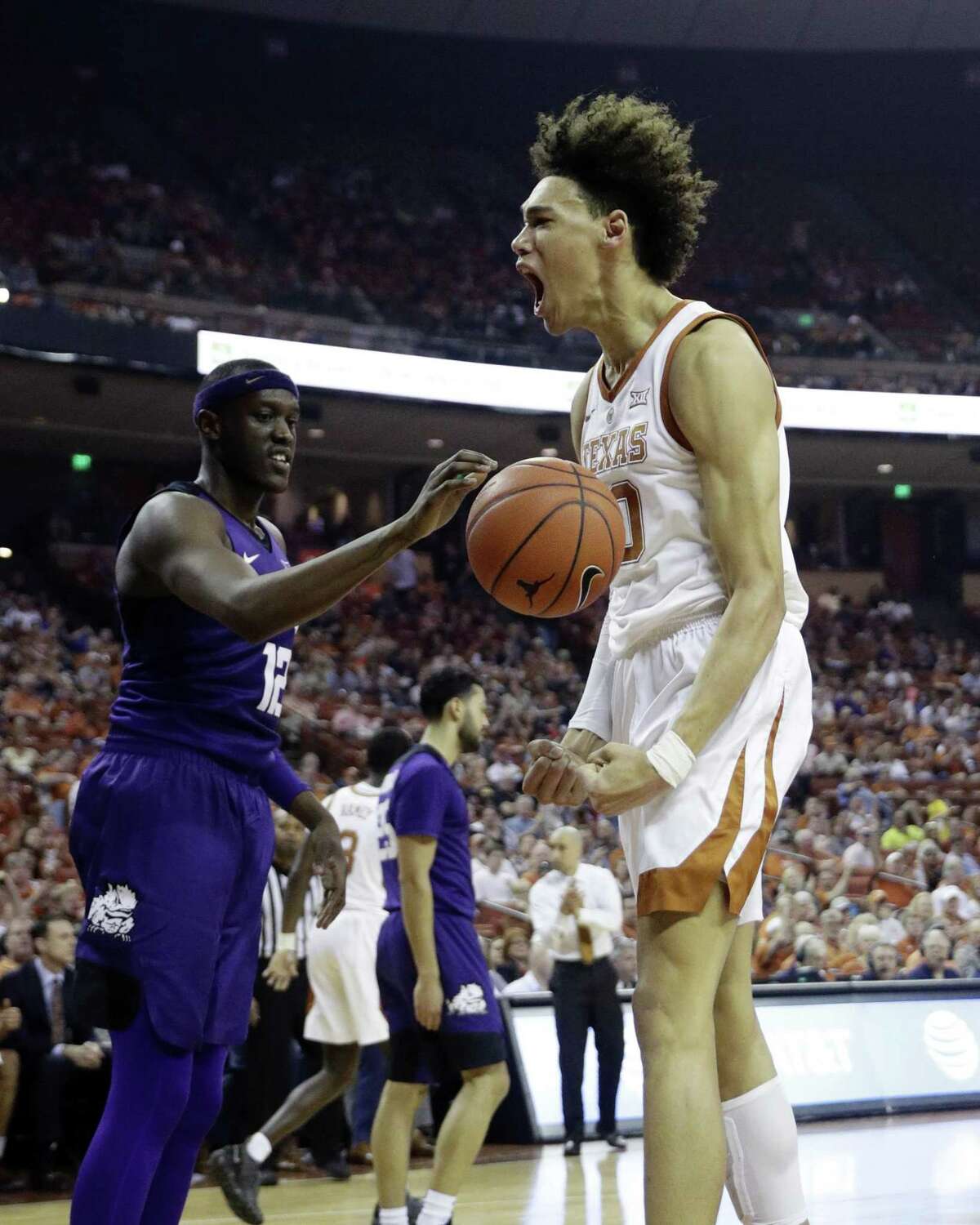 Texas forward Jaxson Hayes, right, reacts after scoring against TCU during the second half of an NCAA college basketball game, Saturday, March 9, 2019, in Austin, Texas. (AP Photo/Eric Gay)