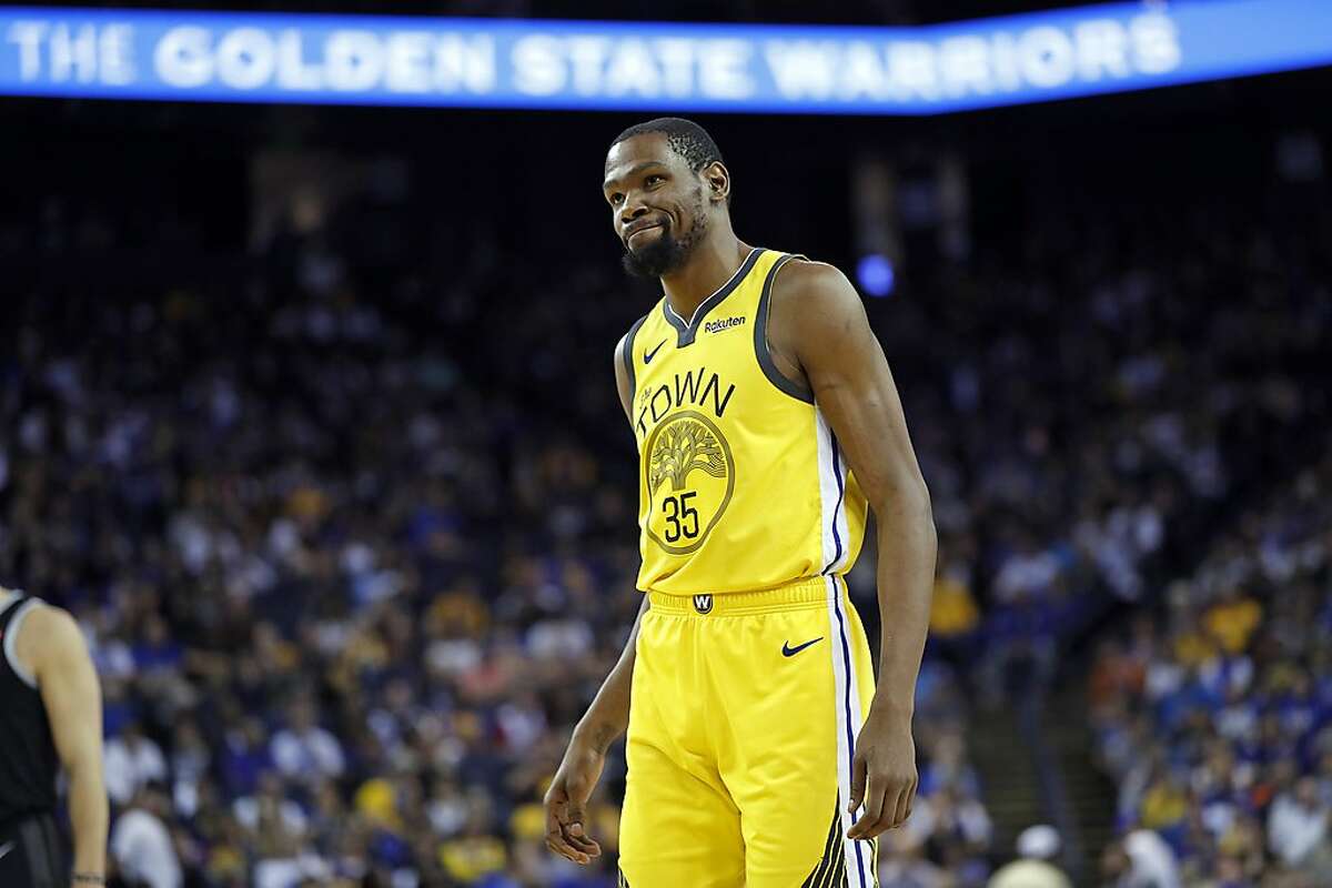 Golden State Warriors' Kevin Durant grimaces in 4th quarter of Warriors' 121-114 win over Detroit Pistons during NBA game at Oracle Arena in Oakland, Calif., on Sunday, March 24, 2019.