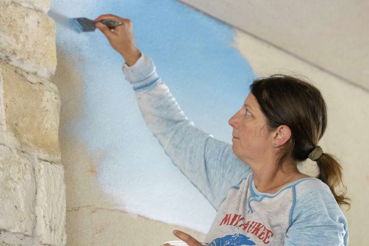 Artist Anat Ronen paints the sky for a mural Tuesday, April 2, 2019 at Creekside Park Village Green in The Woodlands. Ronen began painting the mural Tuesday and is expected to be finished Thursday.