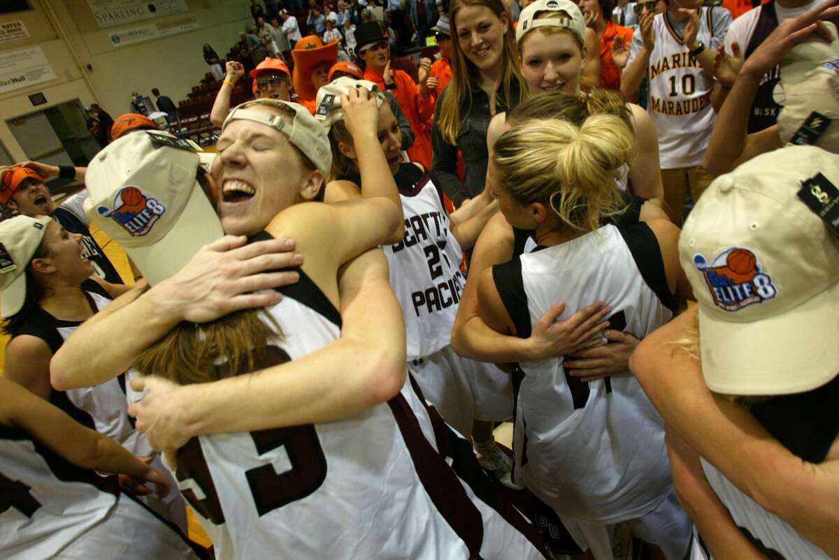 On March 14, 2005 Seattle Pacific University player Carli Smith (facing left) hand teammates rejoice after they beat the Chico State Wildcats at Seattle Pacific University. Final score 85-70.