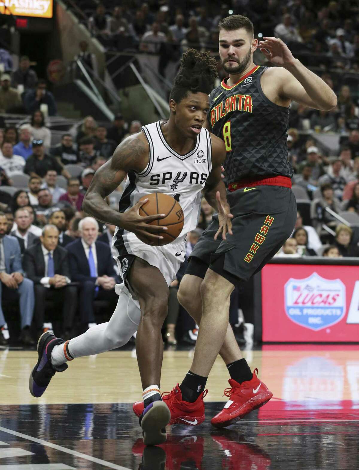 Spurs' Lonnie Walker, IV (01) drives the baseline against Atlanta Hawks' Isaac Humphries (08) during their game at the AT&T Center on Tuesday, Apr. 2, 2019. (Kin Man Hui/San Antonio Express-News)