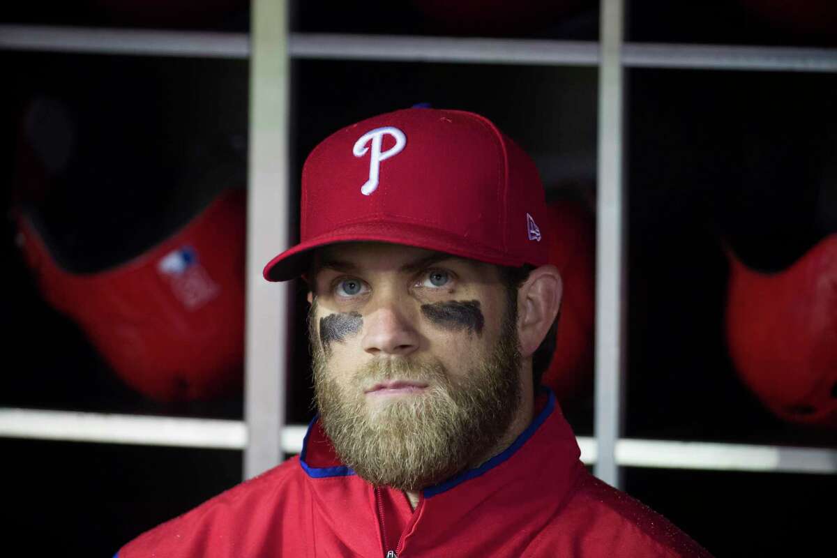 Philadelphia Phillies' Bryce Harper watches a video tribute from the dugout before a baseball game against the Philadelphia Phillies at Nationals Park, Tuesday, April 2, 2019, in Washington. (AP Photo/Alex Brandon)