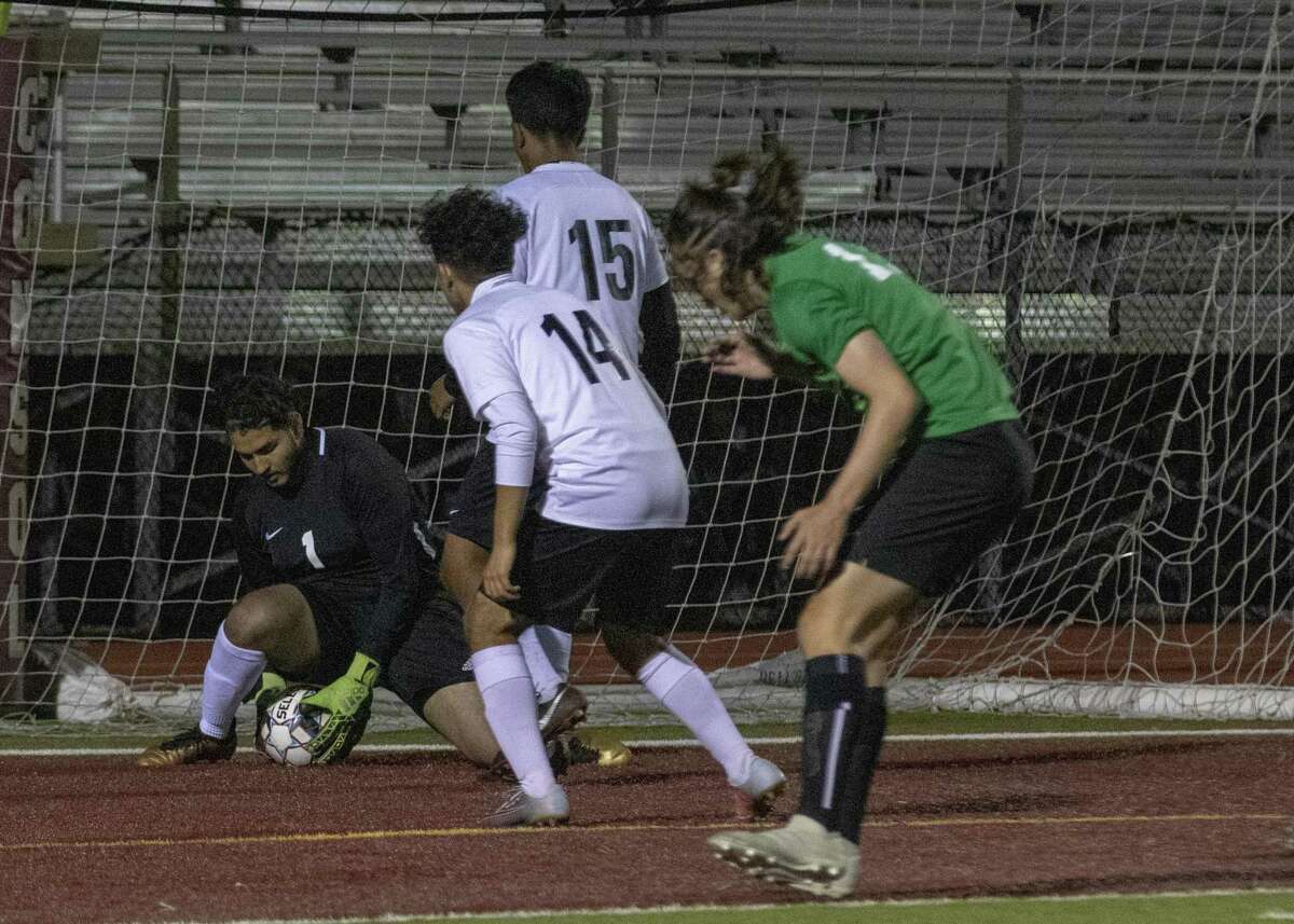 Willis senior Adam Mendez (1) makes a quick save during a Region III-5A playoff soccer match Tuesday, April 2, 2019 at A&M Consolidated High School in College Station.