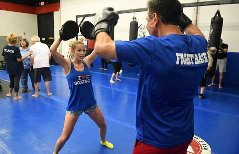 <p>Coach Jenee Cisne, left, leads Thomas Martin during a Rock Steady Boxing program fights back against Parkinson's disease - Houston ...