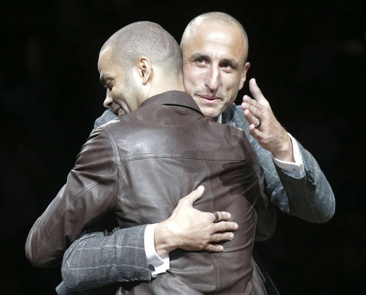 Tony Parker hugs the honoree as Manu Ginobili is celebrated at his retirement ceremony at the AT&T Center following the Spurs game against the Cleveland Cavaliers on March 28, 2019.