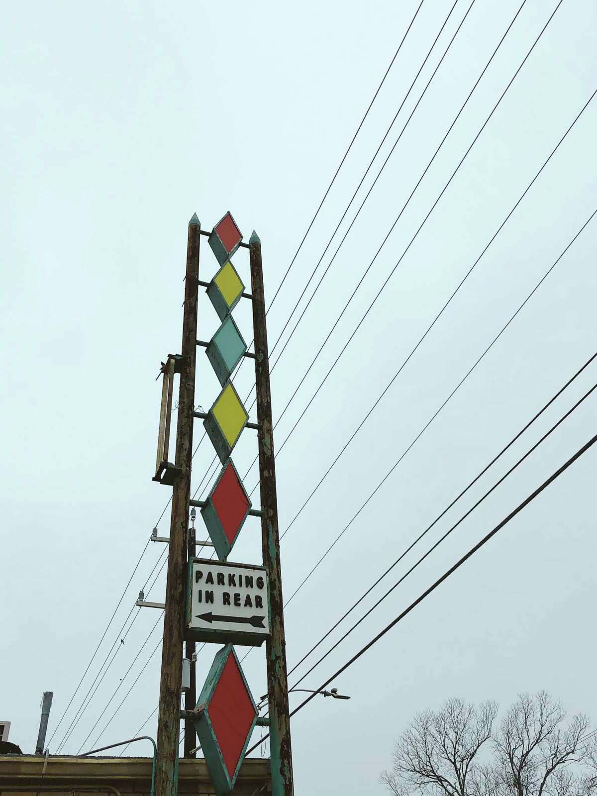Pops of color and geometric patterns, as seen on this detail of a sign for an abandoned business near Broadway and Eleanor Street are common motifs of mid-century modern design.