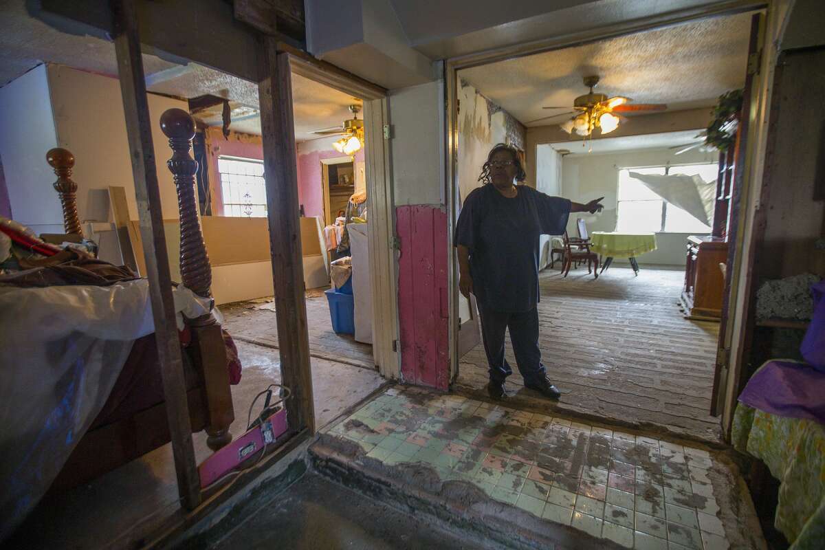 Annie Green stands in her Harvey-damaged home in northeast Houston. She said she has had contractors begin work and disappear.