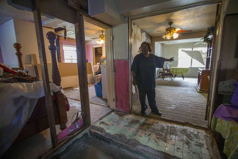 Annie Green stands in her Harvey-damaged home in northeast Houston. She said she has had contractors begin work and disappear. Photo: Mark Mulligan/Staff Photographer
