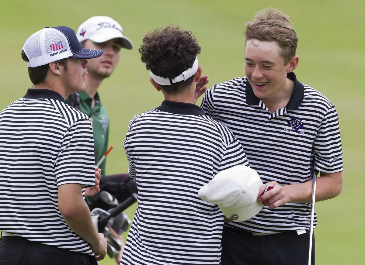 Jack Wiebe of Willis gets a hug from teammates after finishing the final round of the District 20-5A championships on Wednesday, April 3, 2019, in Magnolia.