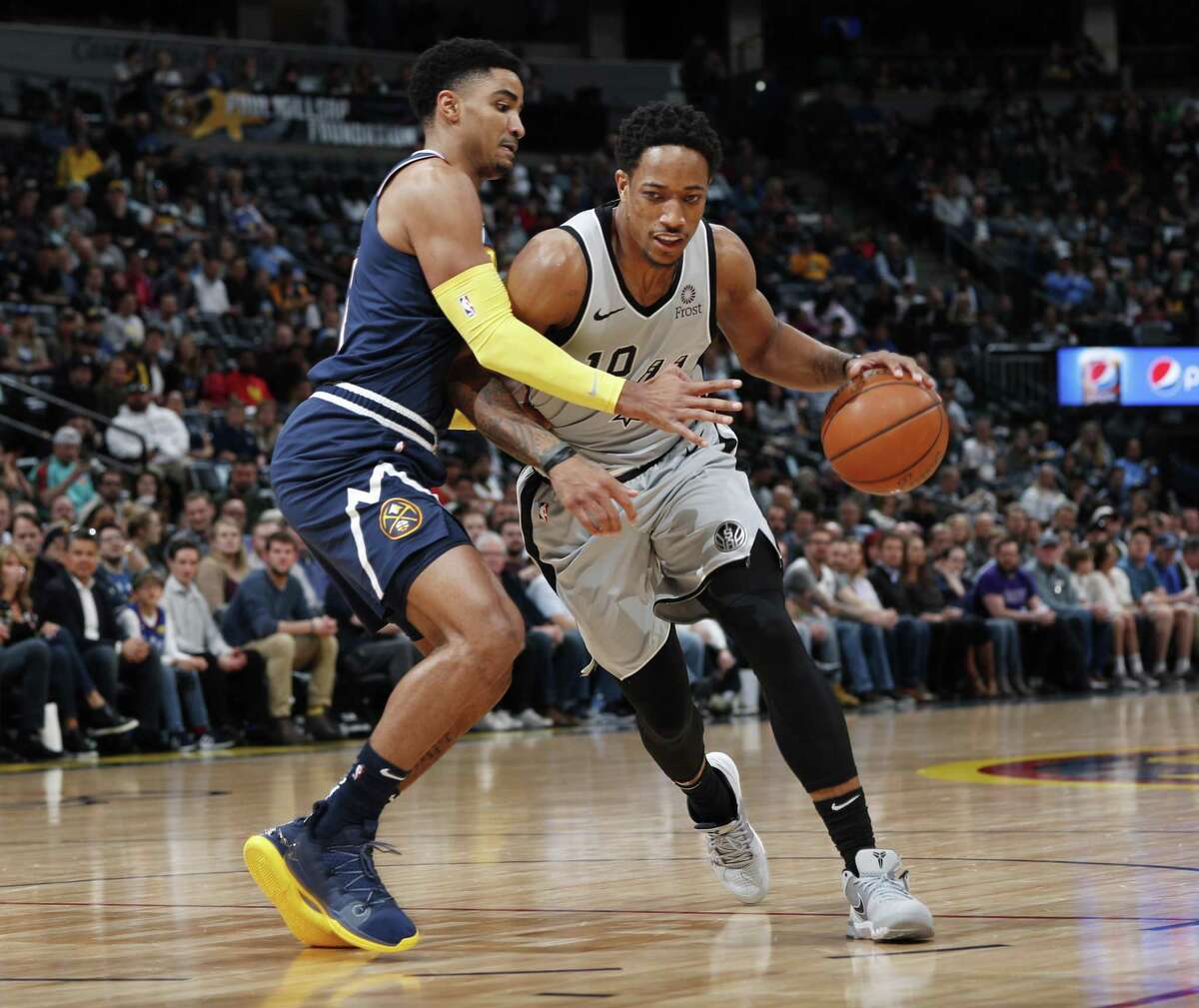 DeMar DeRozan works on Nuggets guard Gary Harris. DeRozan scored just 11 points — more than 10 below his season average — as the Spurs trailed wire-to-wire.