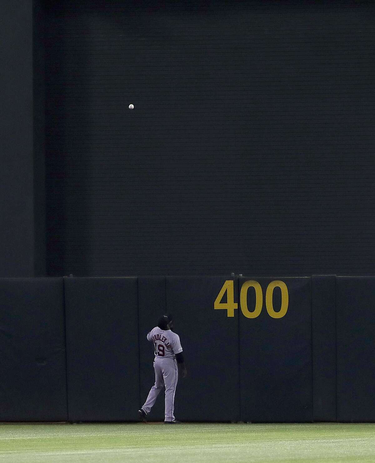 Boston Red Sox center fielder Jackie Bradley Jr. (19) watches a two-run home run hit by Oakland Athletics' Ramon Laureano during the fourth inning of a baseball game in Oakland, Calif., Wednesday, April 3, 2019. (AP Photo/Jeff Chiu)