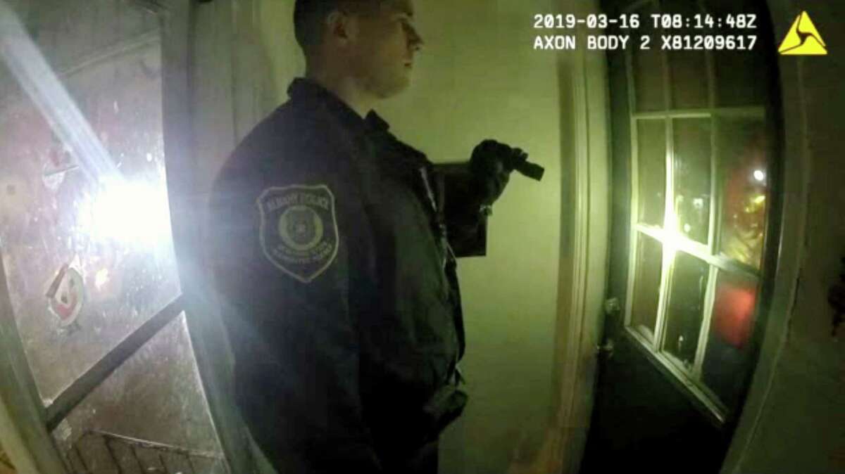 Police body camera footage shows Officer Matthew Seeber asking to enter the home at 523 First Street before kicking-in the door on March 16, 2019, in Albany, N.Y. Three men were beaten by police officers who responded to a residence where late-night parties plagued the West Hill neighborhood. The charges against the men, including resisting arrest or inciting a riot, were dropped after prosecutors reviewed video, including body-cam footage, that indicated the officers were at fault. (Albany Police Department)