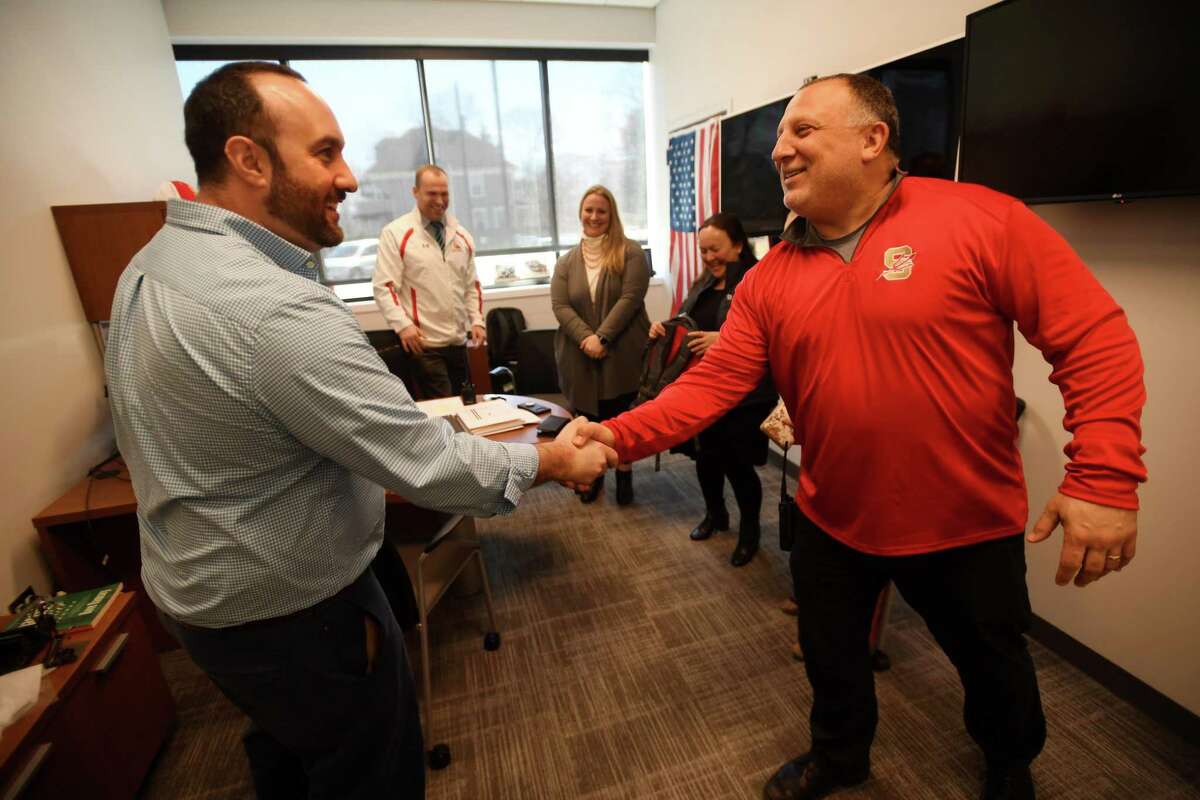 Stratford High math teacher Nicholas Manciero, left, is congratulated by Principal Jack Dellapiano after receiving a five thousand dollar grant and backpack from the Fund for Teachers Foundation at the school in Stratford, Conn. on Thursday, April 3, 2019. Manciero will travel for three weeks to Rome, Florence, and Pisa, Italy to study how mathmatics were used in construction of cathedrals, aqueducts, towers, and monuments during the Roman Empire, Gothic, and Renaissance periods.