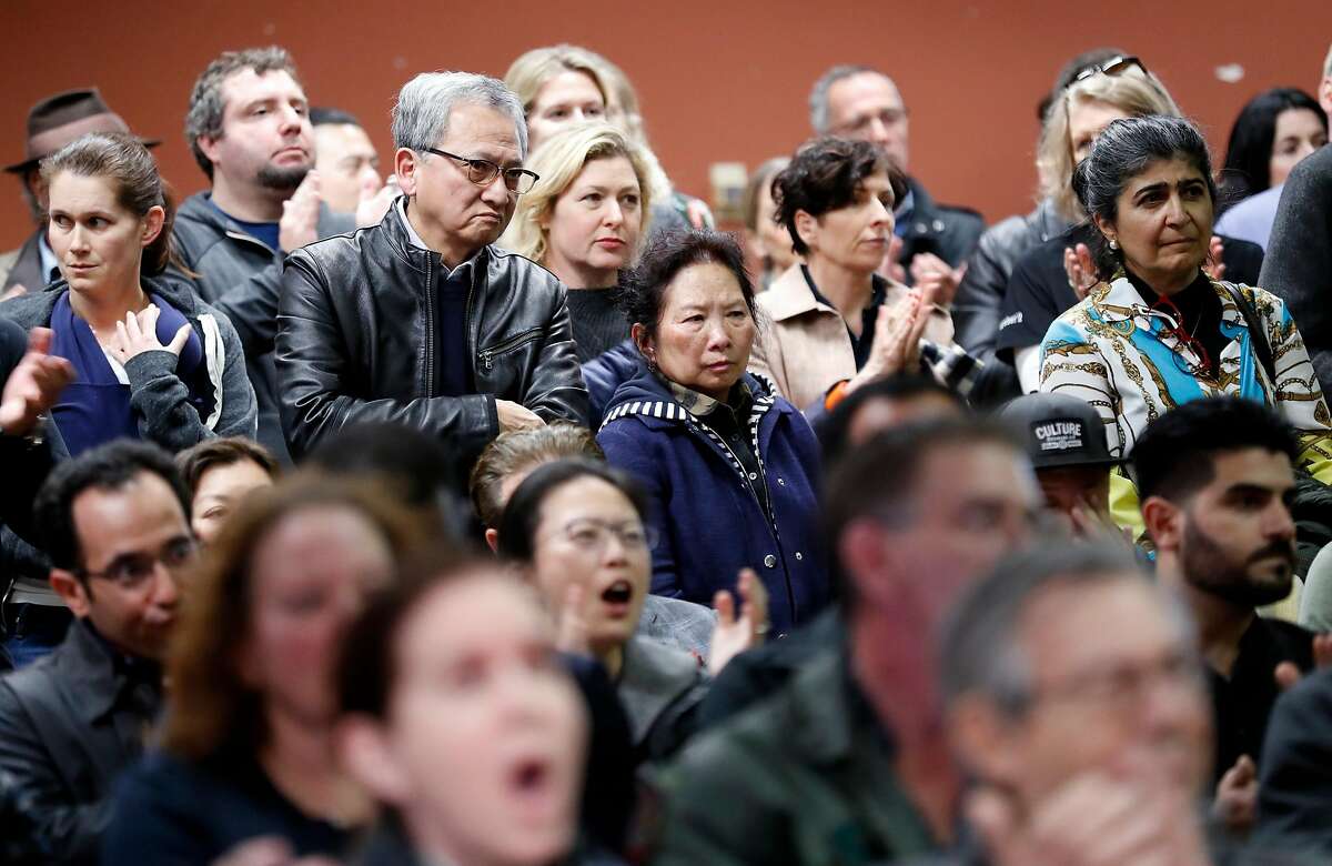 Crowd members react to an area resident speaking out against Embarcadero SAFE Navigation Center during informational meeting at Delancey Street Foundation in San Francisco, Calif., on Tuesday, March 12, 2019.