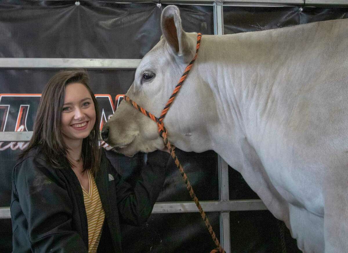 Taylor Turner, 15, of College Park poses with her grand champion steer Merle on Wednesday, April 3, 2019 at the Montgomery County Fair Grounds in Conroe.