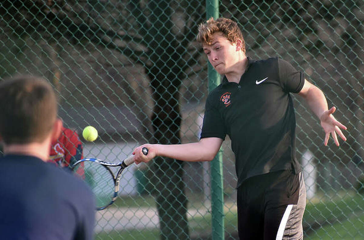 Edwardsville’s Nick Hobin hits a forehand shot during No. 3 doubles with Ben Blake during a regular season match against O’Fallon.