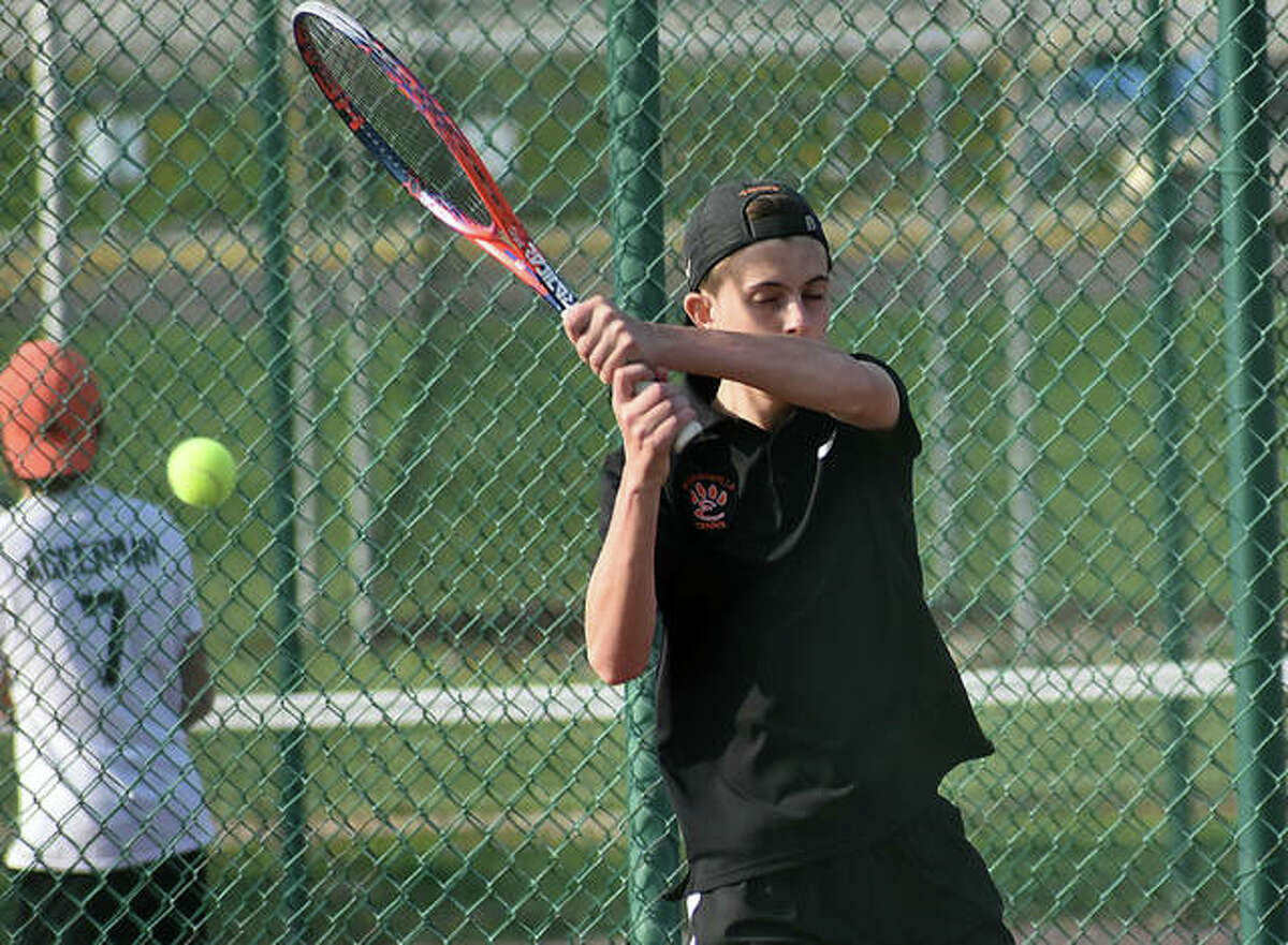 Edwardsville’s Drake Schreiber hits a backhand shot in his doubles match with Zach Trimpe against O’Fallon.