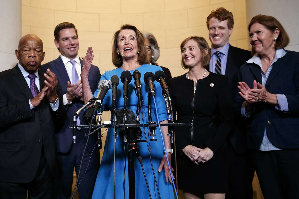 House Minority Leader Nancy Pelosi, D-Calif., joined by from left, Rep. John Lewis, D-Ga., Rep. Eric Swalwell, D-Calif., Rep. Joyce Beatty, D-Ohio., Rep. Kathy Castor, D-Fla., Rep. Joe Kennedy, D-Mass., and Rep. Ann Kirkpatrick, D-Ariz., speaks to media at Longworth House Office Building on Capitol Hill in Washington, Wednesday, Nov. 28, 2018, to announce her nomination by House Democrats to lead them in the new Congress. She still faces a showdown vote for House speaker when lawmakers convene in January. (AP Photo/Carolyn Kaster)