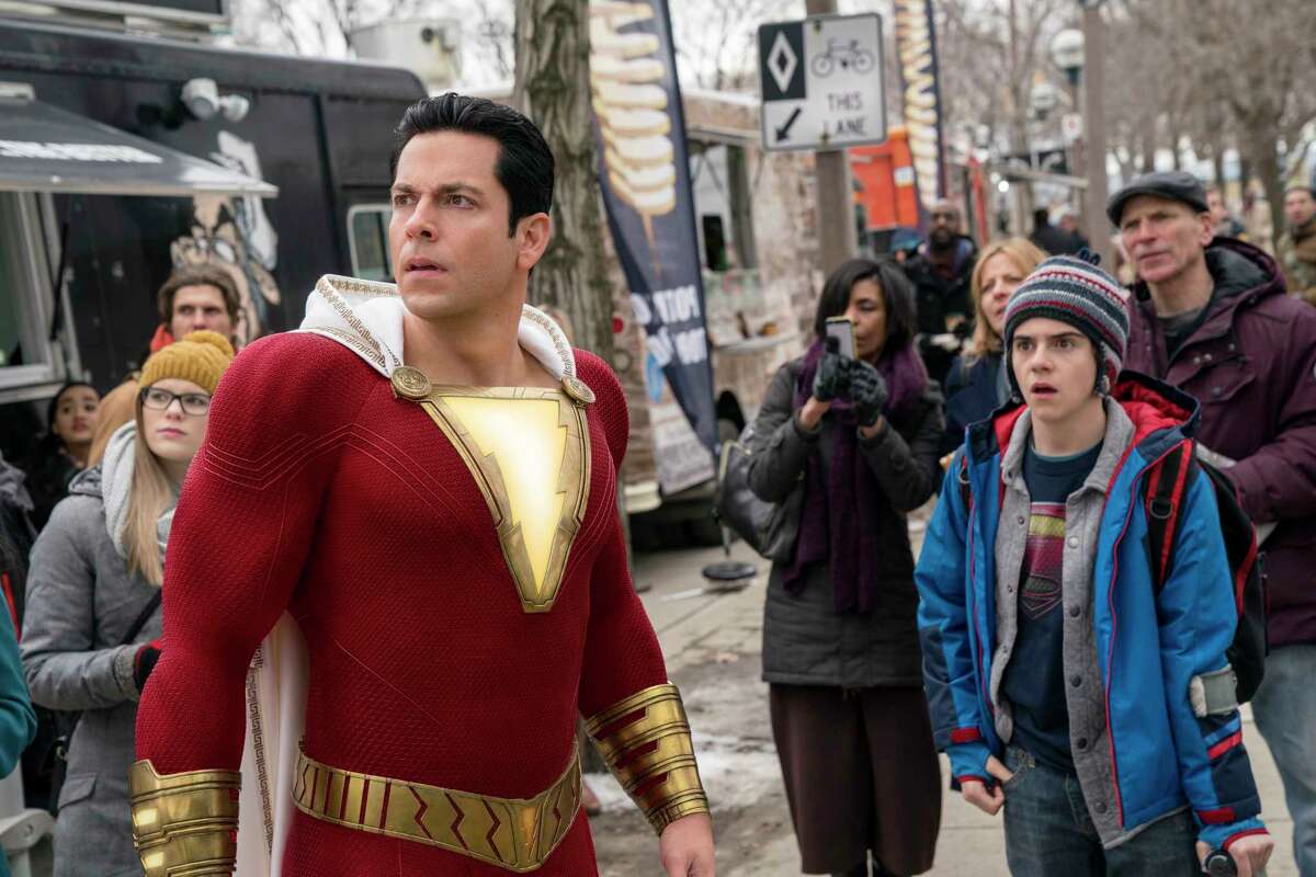 This image released by Warner Bros. shows Zachary Levi, left, and Jack Dylan Grazer in a scene from "Shazam!" (Steve Wilkie/Warner Bros. Entertainment via AP)