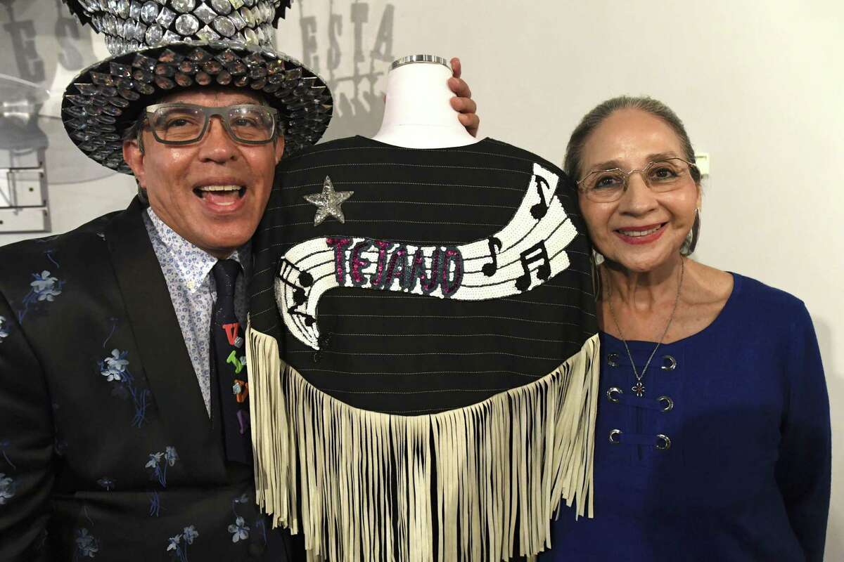 Michael Quintanilla and Graciela Carrillo stand with one of Carrillo’ works, worn at the Tejano Music Awards by Maria Elena Torralva-Alonso in the 1980s.