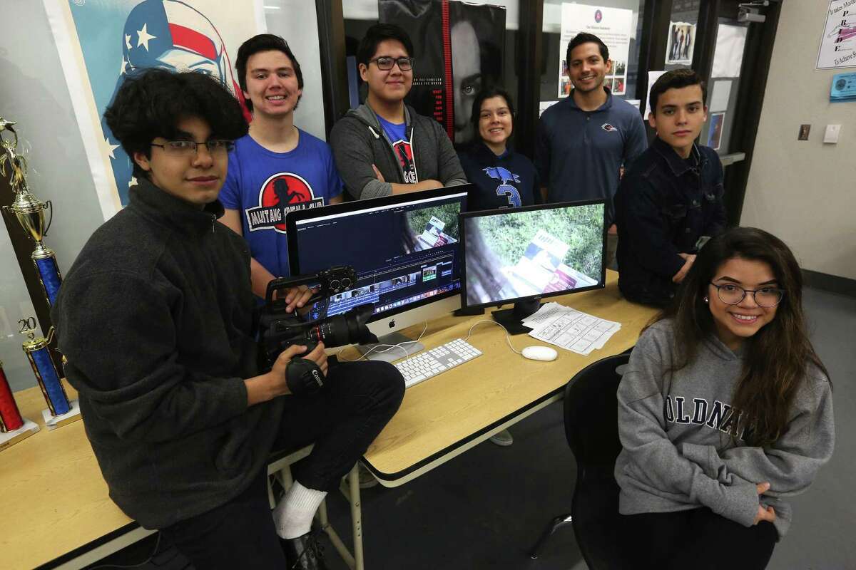 Michael Reyes, from left, Aaron Delafuente Michael Carreon, Alyssa Garcia, teacher Will Callahan, Damian Dominguez, and Bryanna Jimenez pose Thursday, April 4, 2019 around a computer displaying the fundraising video they made for Meals on Wheels which will be debuted at BexarFest, a multimedia festival held at the Tobin Center.