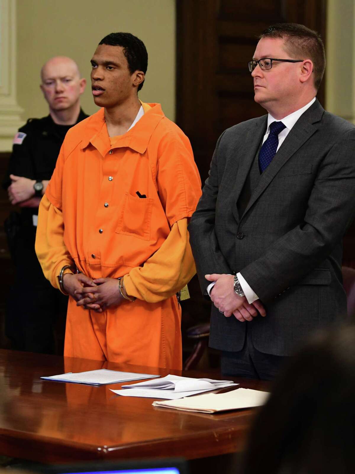 Justin Mann answers questions from Judge Debra Young as he pleads guilty to four counts of second degree murder for the December 2017 quadruple homicide in Lansingburgh in Rensselaer County Court on Friday April 5, 2019 in Troy, N.Y. Defense attorney Joseph Ahearn stands next to him. (Lori Van Buren/Times Union)