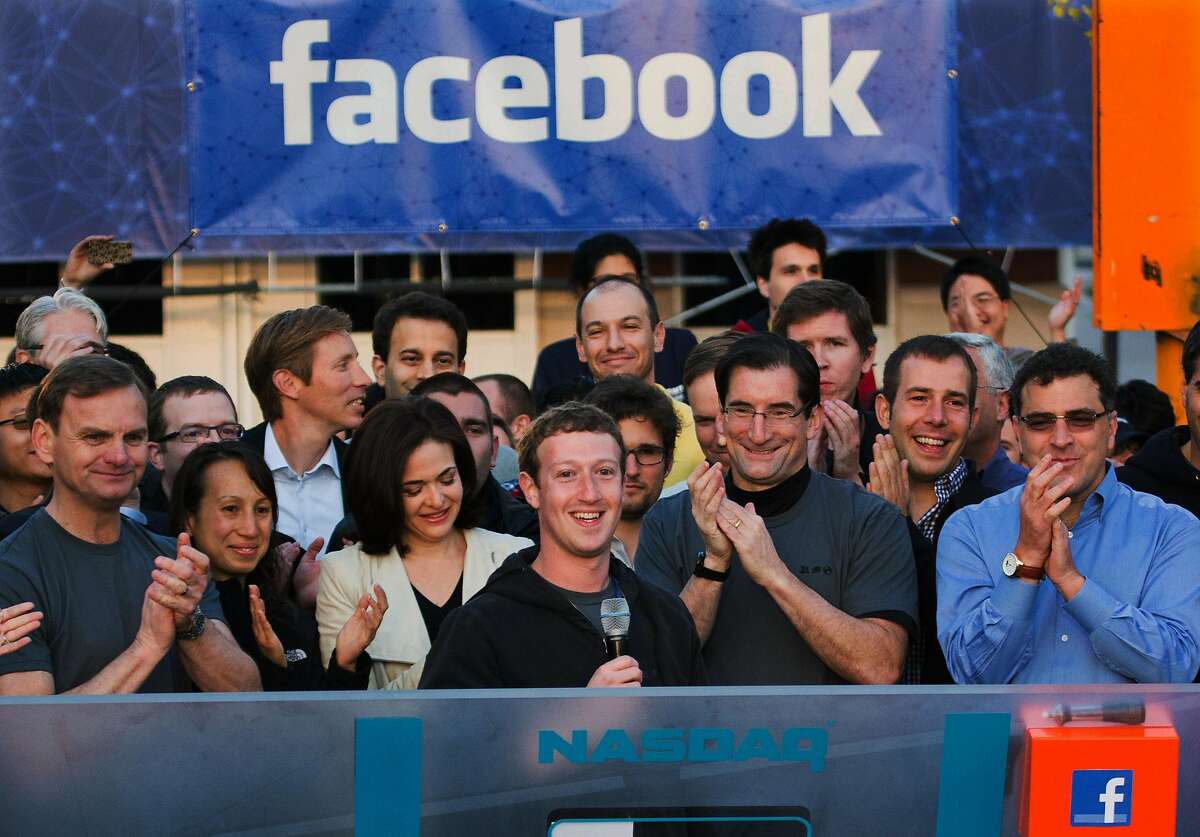 In this May 18, 2012 file photo provided by Facebook, Facebook founder, Chairman and CEO Mark Zuckerberg, center, rings the Nasdaq opening bell from Facebook headquarters in Menlo Park, Calif. Years of anticipation led to Facebook's initial public offering of stock in 2012, the hottest Internet IPO since Google’s in 2004. Many of the 1 billion-plus users of the world’s largest online social network craved a chance to buy in early. On the eve of its first trading day, Facebook’s market value was $105 billion, yet the IPO bombed. (AP Photo/Nasdaq via Facebook, Zef Nikolla, File)