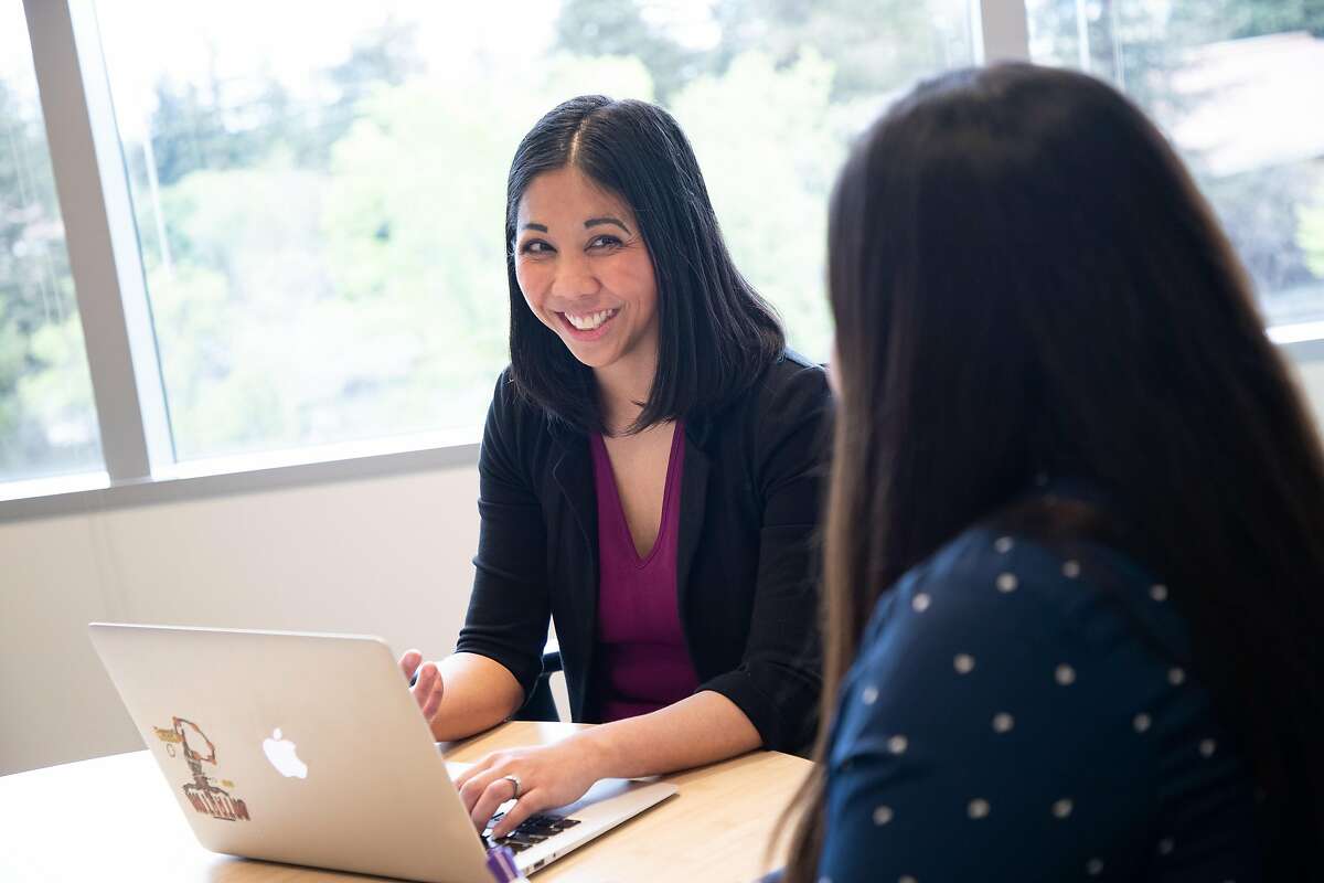 Lynsey Reyes-Nickel, at left, converses Destiny Hoag, a co-worker, at Datastax on Friday, April 5, 2019, in Santa Clara, Calif. After taking four years off work to care for her sick newborn, then her sick husband, Reyes-Nickel found it hard to get back to work because the gap in her resume worried recruiters. She finally participated in a returnship at Datastax. one month into the four-month internship, she was offered a full-time job at the company.