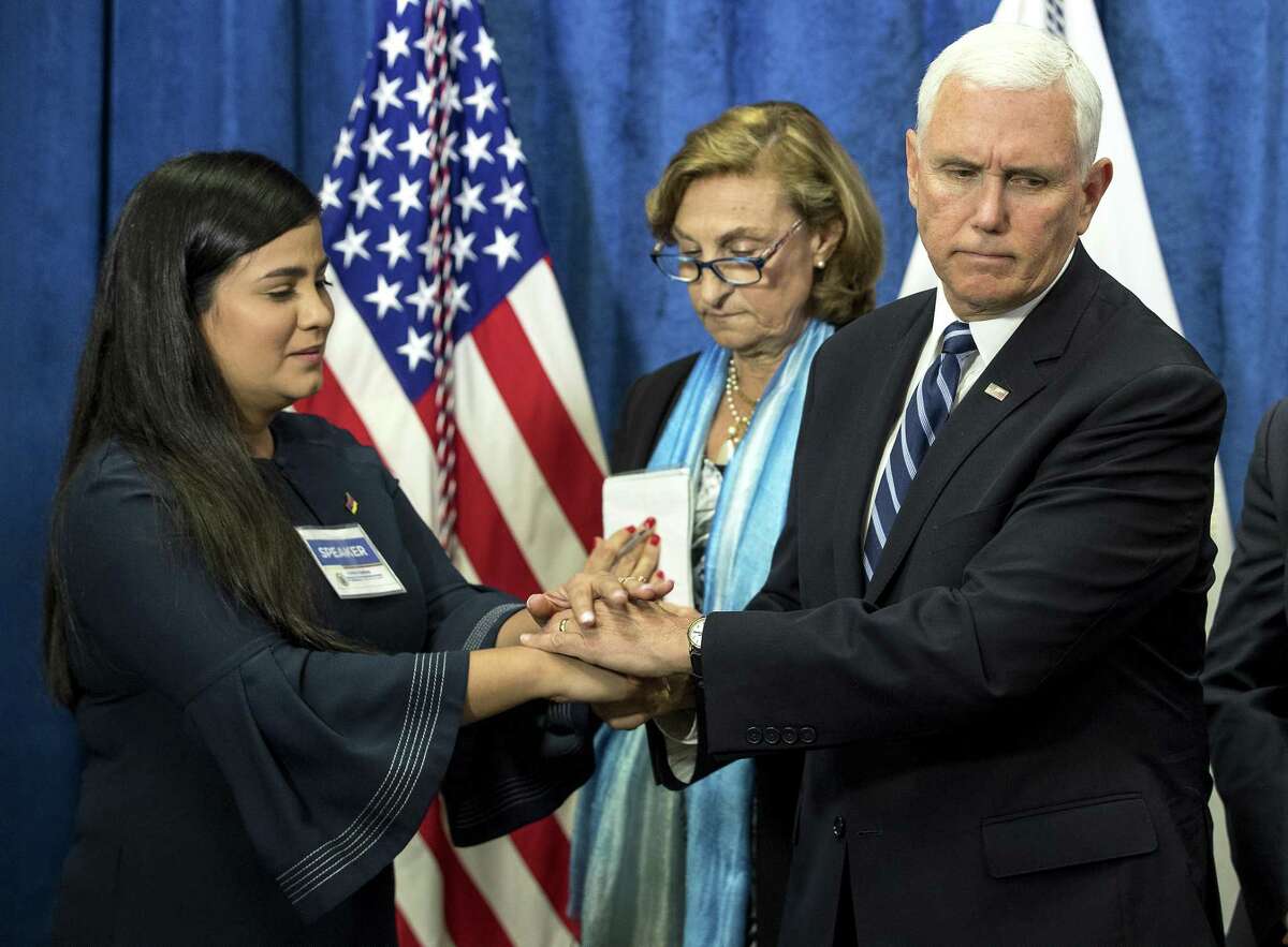 Vice President Mike Pence shakes hands with activist Christina Bastidas as he greets a group of displaced Venezuelans before giving a speech on the crisis in the South American country at Rice University’s Baker Institute for Public Policy on Friday, April 5, 2019, in Houston.