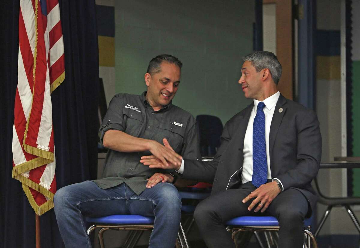 Mayor Ron Nirenberg and Greg Brockhouse finally acknowledge each other as they prepare to begin the mayoral forum at Highland Hill Elementary School on Monday April 1 , 2019.