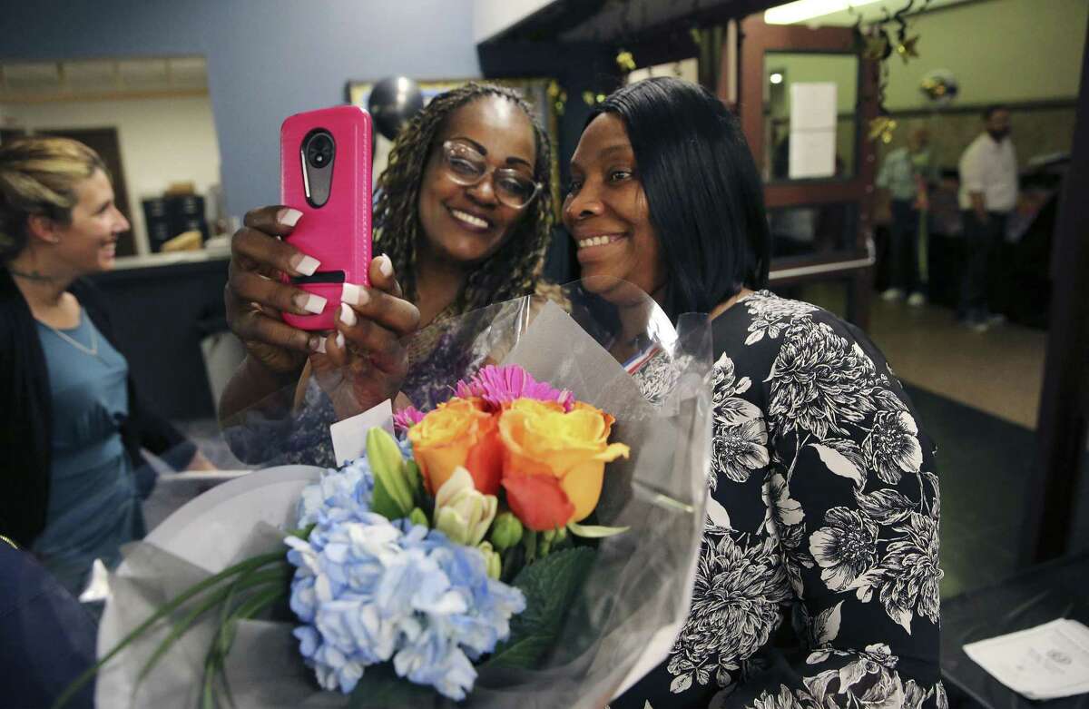 Drug Court Graduate Jessica Spears (right) poses for a picture with Dana Carter, a former 2016 graduate, after Spears joined forty-three other graduates of the Bexar County Specialty Treatment Courts who were honored at a ceremony at the Cadena-Reeves Justice Center on Friday, Apr. 5, 2019. Spears spoke at the ceremony telling her story of how her life spiraled downward with drug abuse but with the help of the drug court she has been sober since 2017 and now helps counsel others with substance abuse. Hailed as a way to save taxpayer funds and provide meaningful solutions to non-violent crime, the Bexar County Felony Drug Court will graduated 44 people from its court and two other specialty courts that hand repeat felons and DWI offenders. The courts, a key component of the county's therapeutic justice approach, keeping people out jail and instead providing counseling, mental health services and assistance with employment, housing, education and transportation. With family and friends in attendance, each graduate received a certificate of completing a drug treatment program from Drug Court Magistrate Ernie Glenn. (Kin Man Hui/San Antonio Express-News)