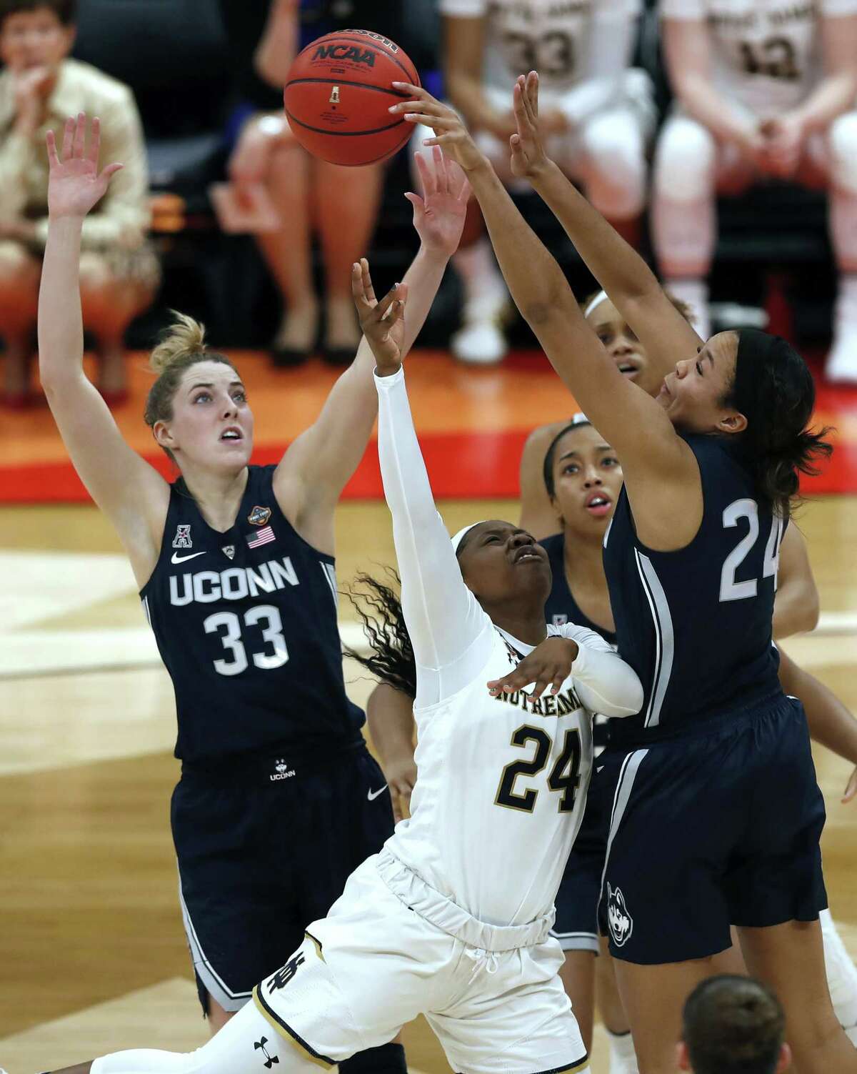 Notre Dame guard Arike Ogunbowale (24) has her shot block as UConn guard Katie Lou Samuelson (33) and forward Napheesa Collier defend during a Final Four semifinal of the NCAA women’s college basketball tournament on Friday in Tampa, Fla. Both Samuelson and Collier will be leaving for the WNBA at the end of the school year.