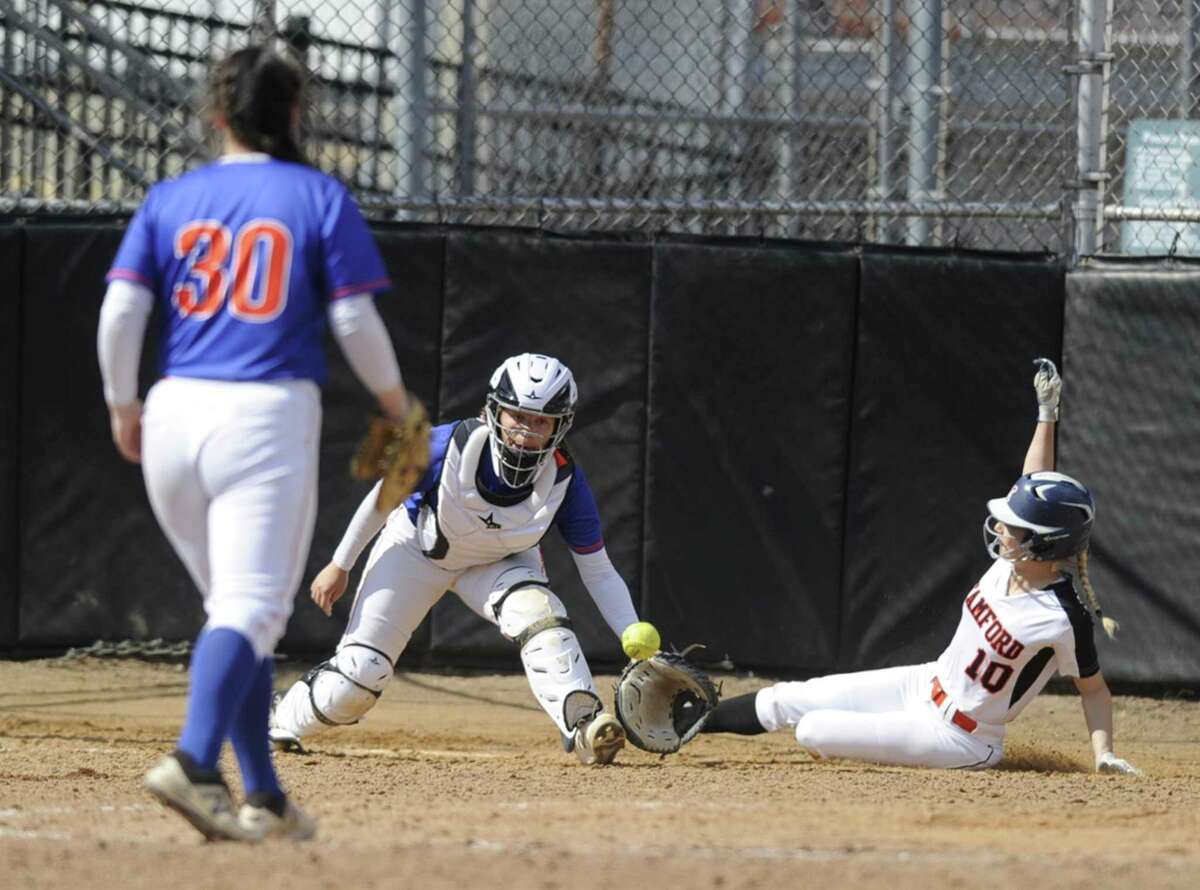 Stamford’s Brycelin Stalteri scores ahead of the throw to Danbury catcher Trinadey Santiago in the 10th inning for the Black Knights’ 7-6 victory on Saturday.