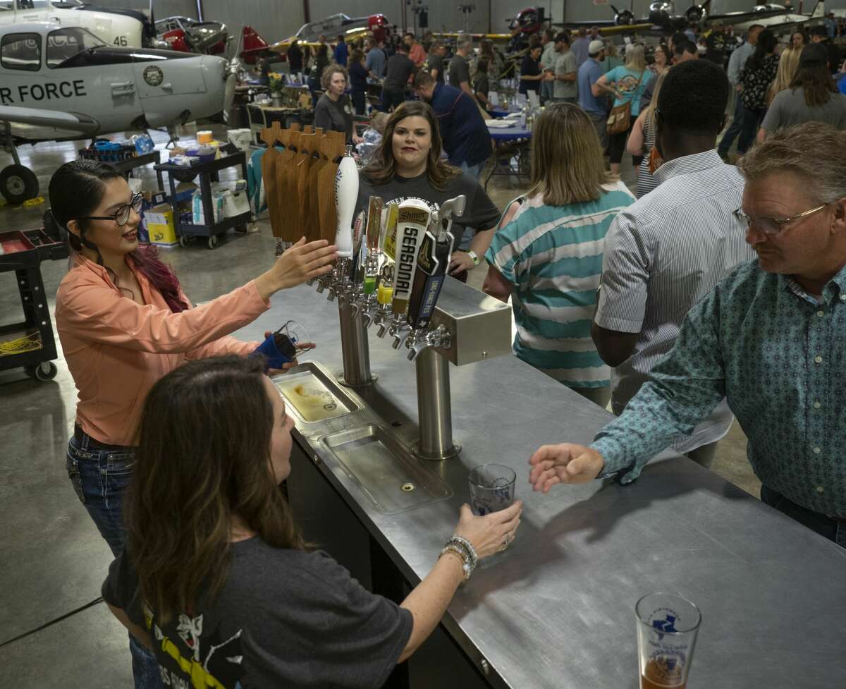 Beer lovers enjoy a night of tasting 04/06/19 at the High Sky Wing of the CAF Hops & Props fundraiser in the High Sky Wing hanger. Tim Fischer/Reporter-Telegram