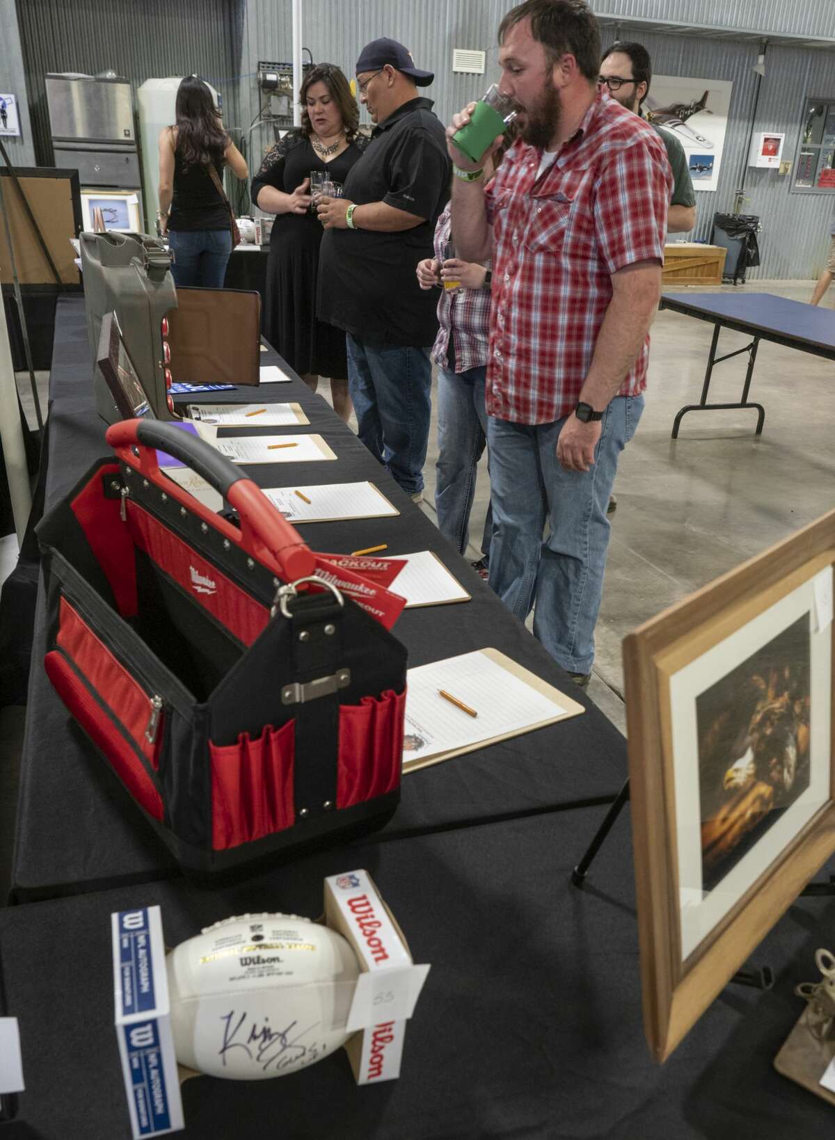 Beer lovers enjoy a night of tasting 04/06/19 at the High Sky Wing of the CAF Hops & Props fundraiser in the High Sky Wing hanger. Tim Fischer/Reporter-Telegram
