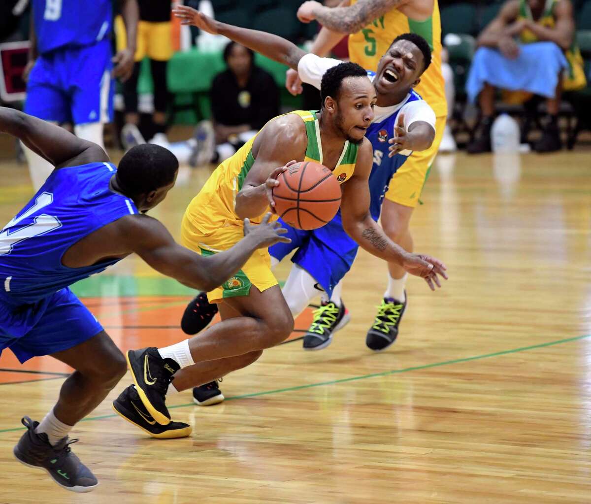 Albany Patroons' Shadell Mullinghaus (center) moves the ball past Jamestown Jackals players Austin Hamilton (11) and Corey Wilford in the first half of their The Basketball League basketball game in Albany, N.Y., Sunday, April 7, 2019.