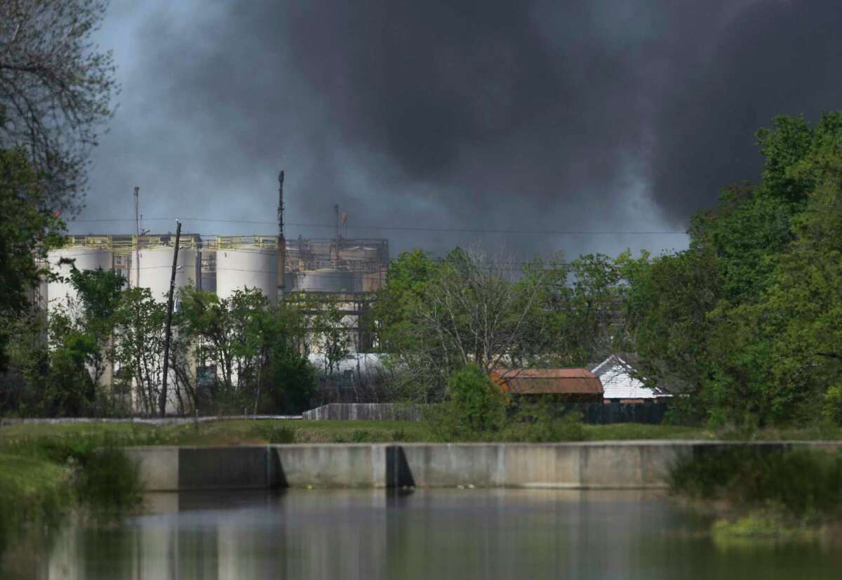 A plume of smoke rises over a fire at the KMCO plant following an explosion Tuesday, April 2, 2019, in Crosby, northeast of Houston, Texas.