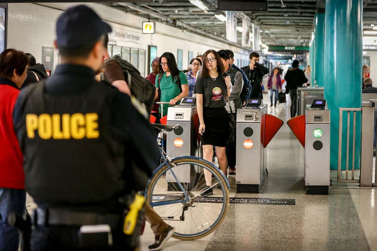 Police officer S. Nho stands guard at Powell Station BART entrance watching for fare evaders as part of BART's large-scale fare evasion enforcement action on Monday, April 8, 2019 in San Francisco, Calif.