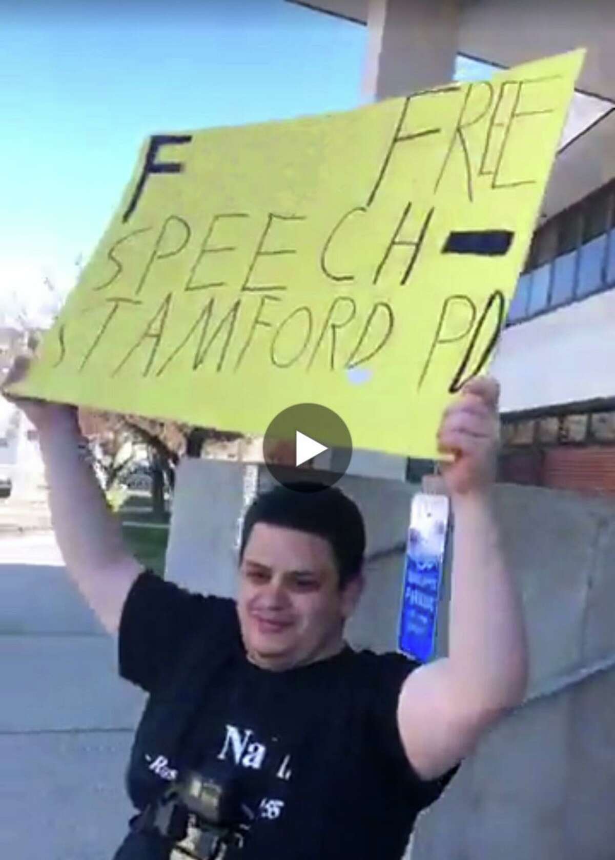 NOTE: photo has been altered to take out offensive language. Michael Picard held a sign outside the Stamford courthouse and the police department Thursday, April 26, 2018 in protest of a friend's arrest for interfering with a distracted driving checkpoint.